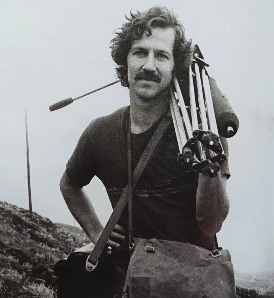 Figura 4 - ll regista tedesco W.Herzog a La Guadaloupe mentre sale verso la sommità del vulcano con la sua attrezzatura cinematografica (Foto: Werner Herzog Film, Behind the Scenes e [2]).